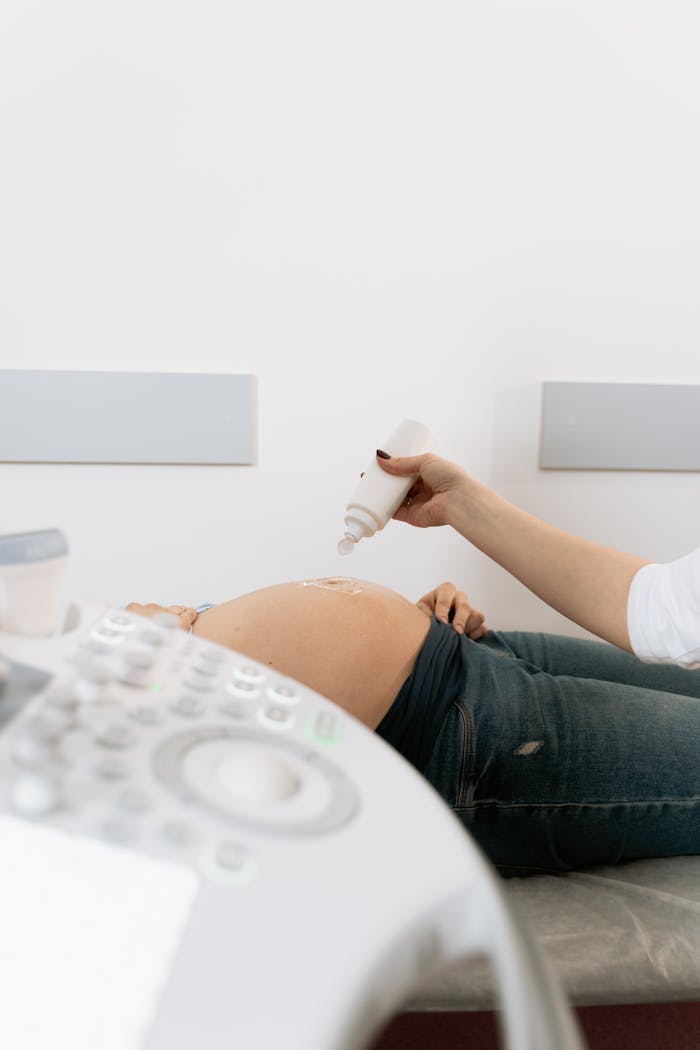 services-05 A pregnant woman receives an ultrasound exam in a medical clinic.
